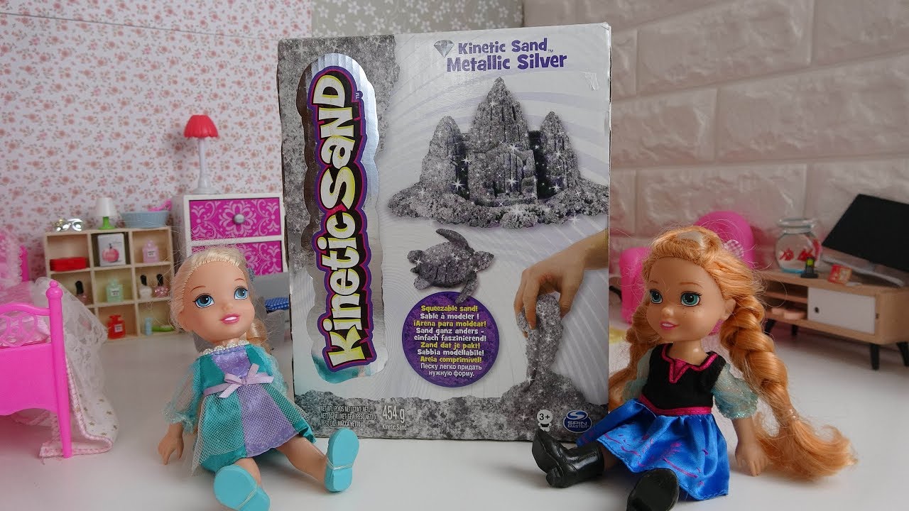 Elsa and Anna toddlers play with kinetic sand