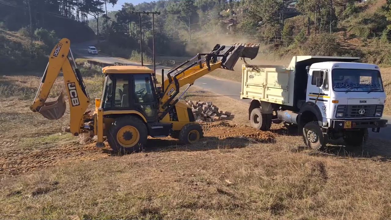 jcb 3dx super loading stone in a 1618 dump truck