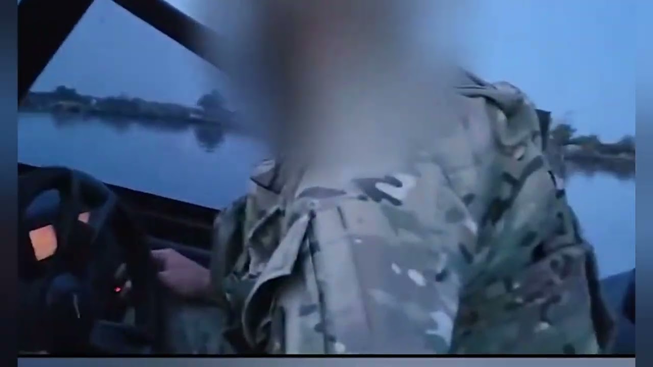 Ukrainian soldiers crossing the Dnipro River to attack Russian positions at dawn.