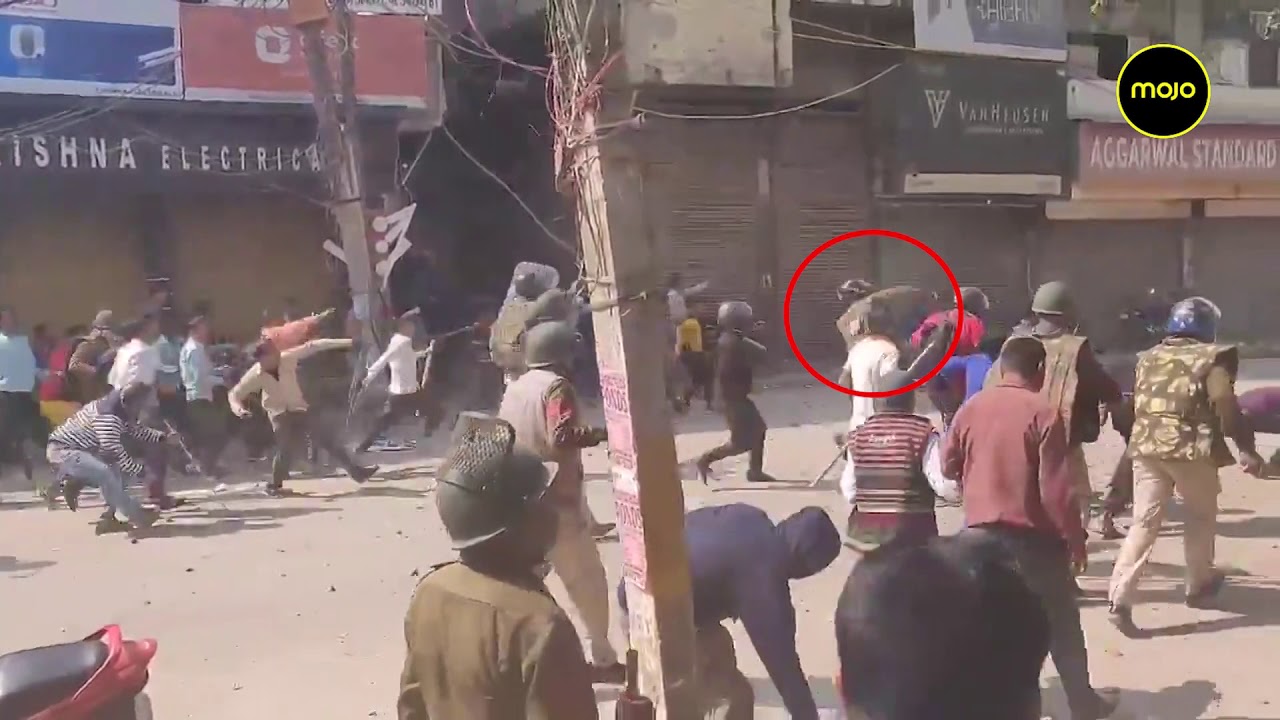 New Video shows Police pelting stones at crowd along with a mob