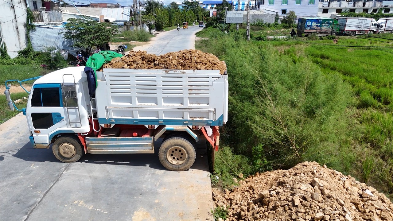 Smooth and skilled operation! Heavy equipment moving stone and soil to transform the land.