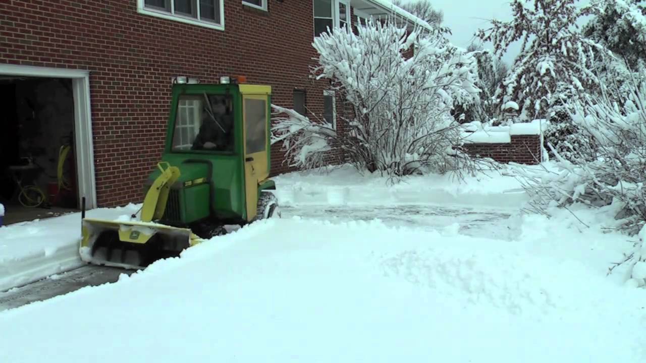 John Deere 318 throwing snow