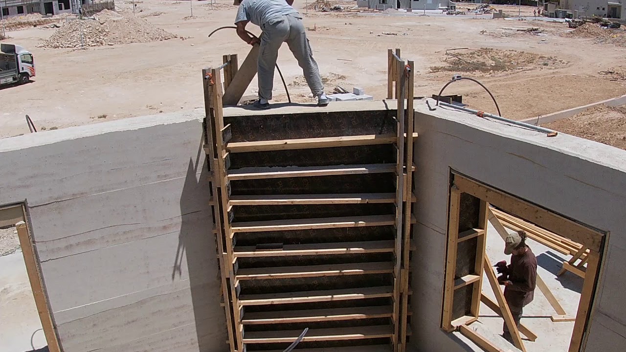overlap rammed earth- ramming and exposing the wall