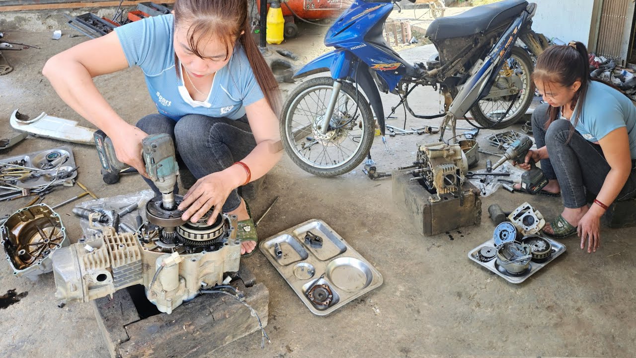 The girl repaired a badly damaged motorbike.