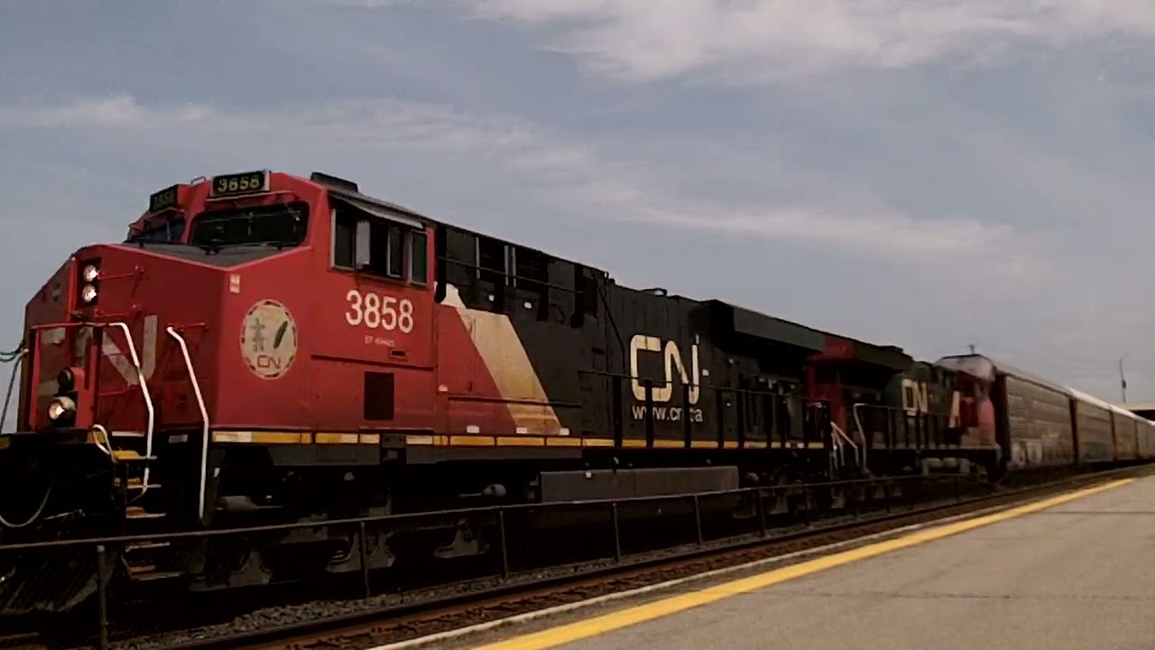 CN 271 w/ CN Engine 3858 & 3037 lead this 292 axle, WB Autorack train by Kingston VIA Station