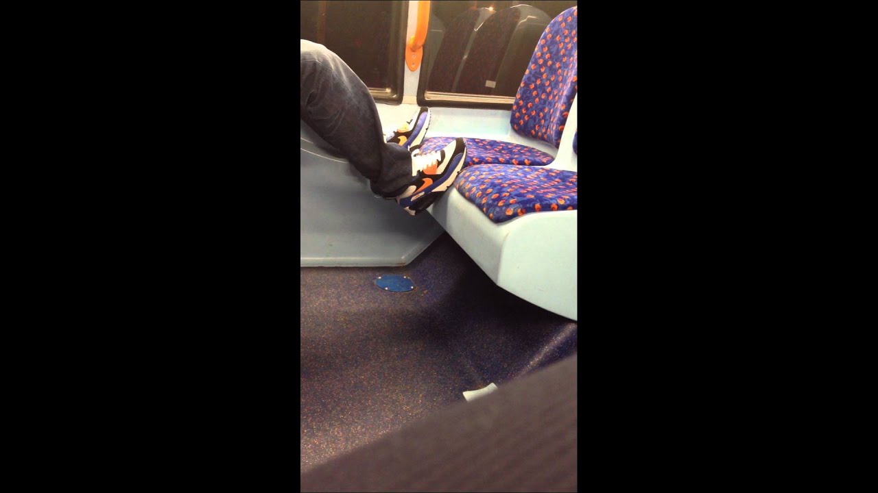 Lad on bus with Nike Air Max 90