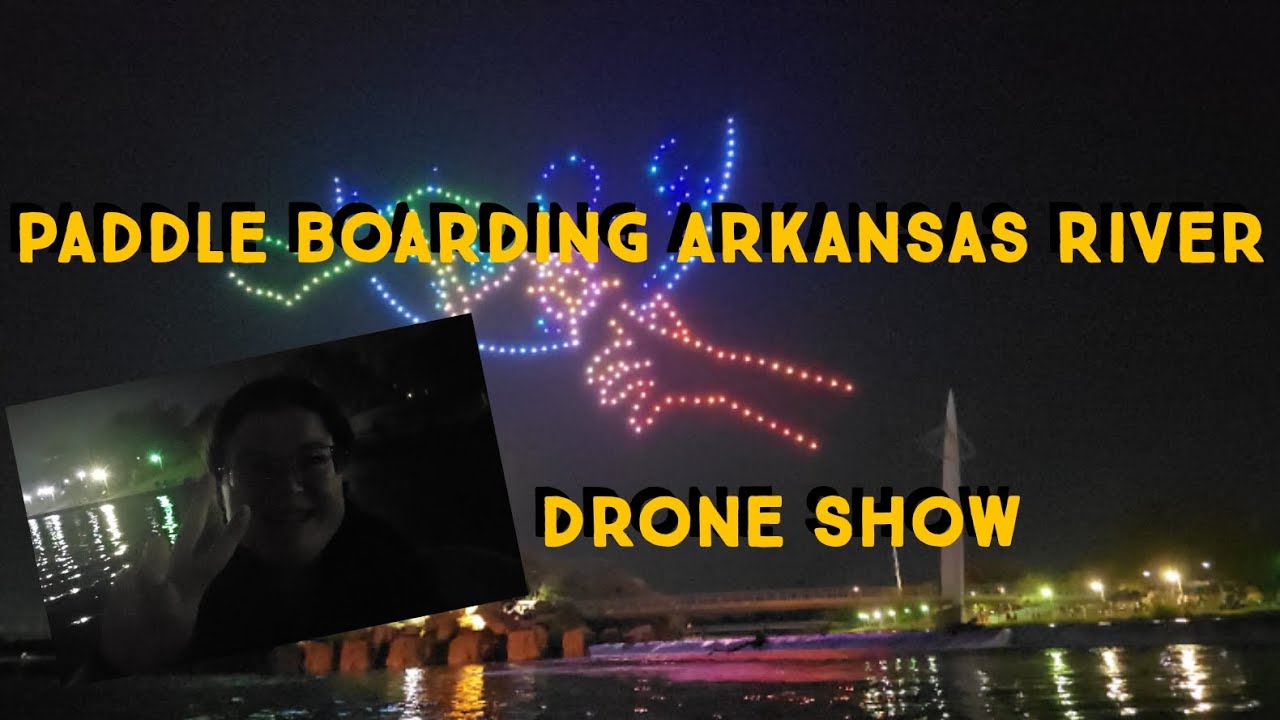 Paddle boarding Arkansas River to see a Drone show.