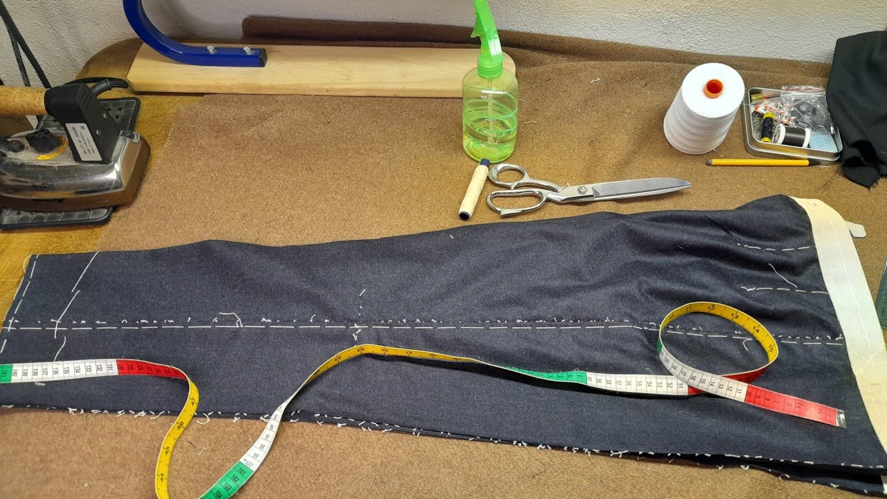 Pantalone di alta sartoria: imbastitura cavallo e orlo.