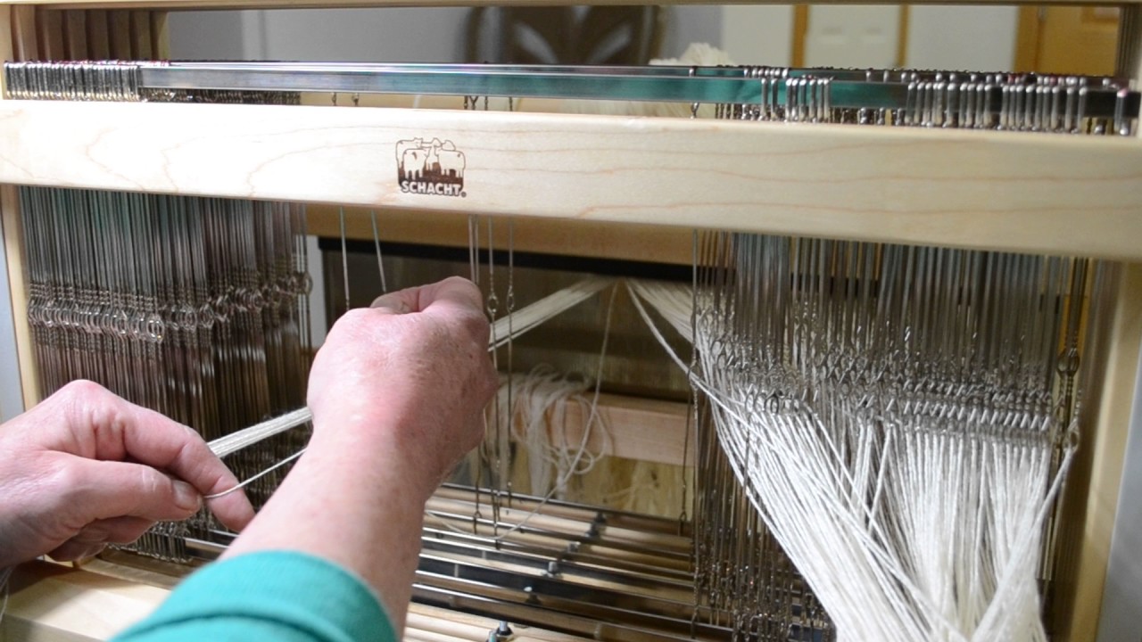 Dressing the loom from front to back & threading the heddles.