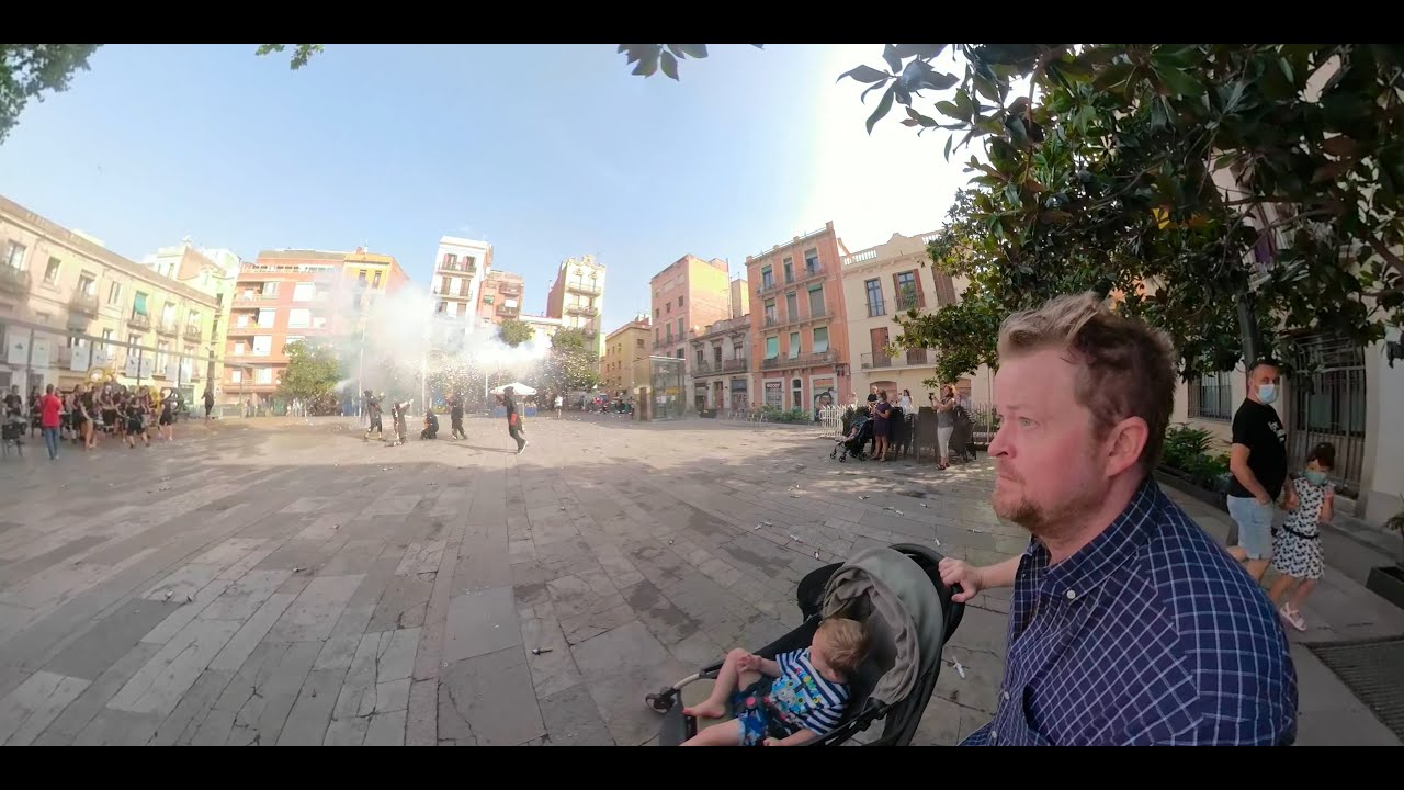 Barcelona street festival.360 travel video. father and son exploring Gracia. fireworks and drums.