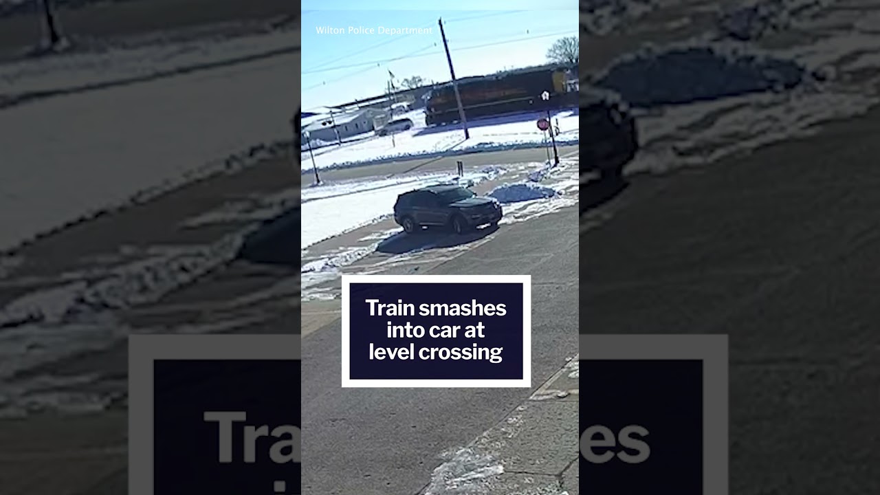 Dramatic moment a rain SMASHES into car at level crossing
