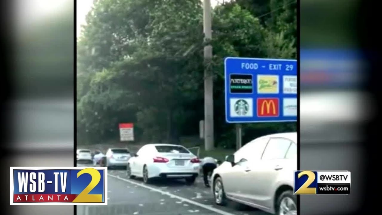 RAW VIDEO: Drivers race to catch money that fell out of an armored truck on the highway