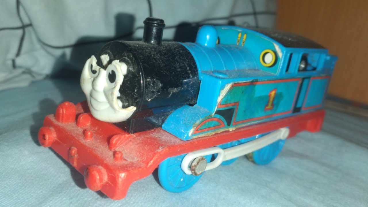 photos of broken and well loved childhood thomas toys with slow music