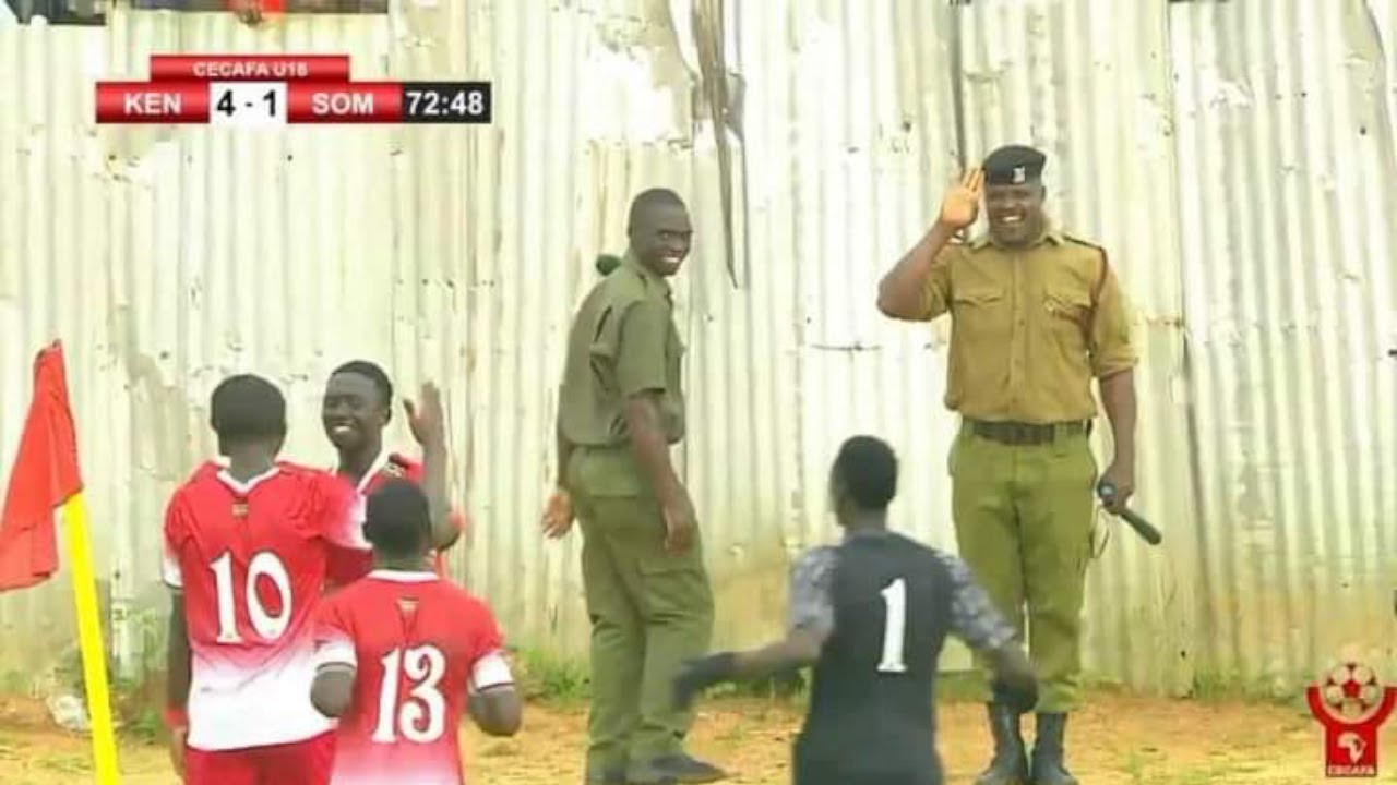 A police officer salutes Aldrine Kibet for a stunning goal in game between Kenya Vs Somalia
