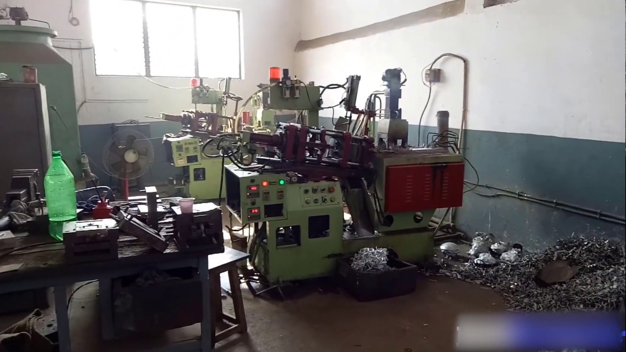 belt buckle manufacturing workshop vibratory finishing