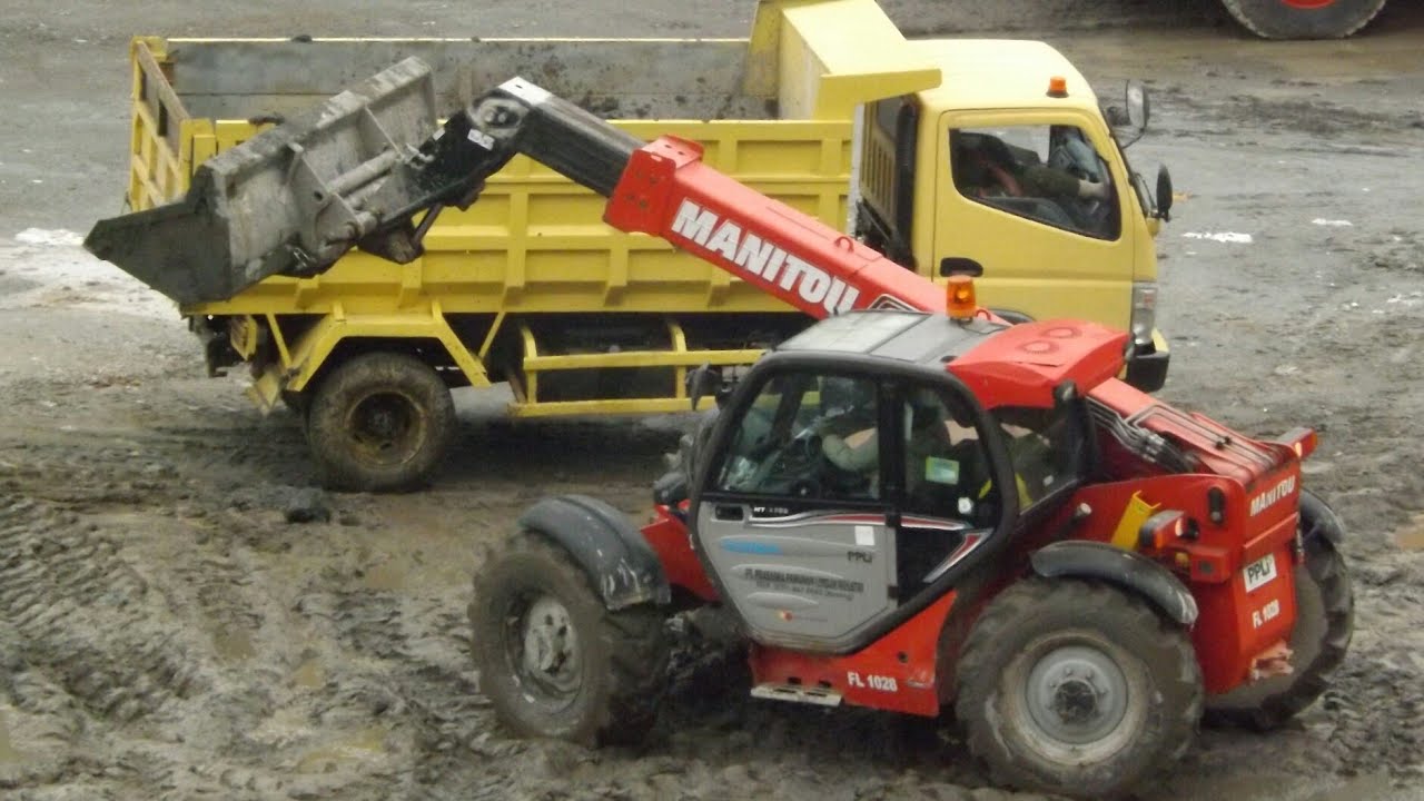 Manitou Telehandler loads the mud onto the dump Truck