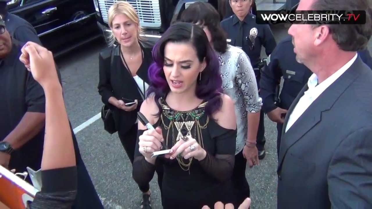 Katy Perry with purple hair signs autographs at Part Of Me film premiere