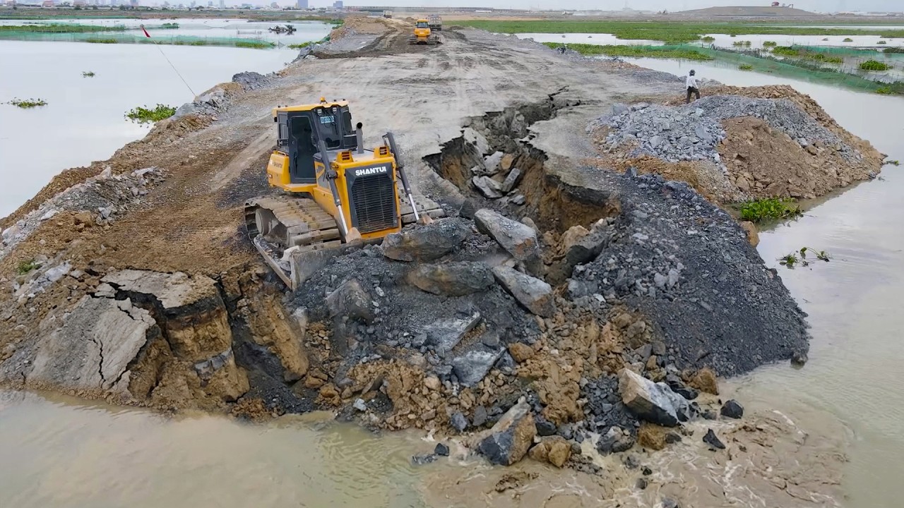 Be Careful! Dump Truck Transport Stone into Lake Bulldozer Push Stone, Being Filling on Damaged Road