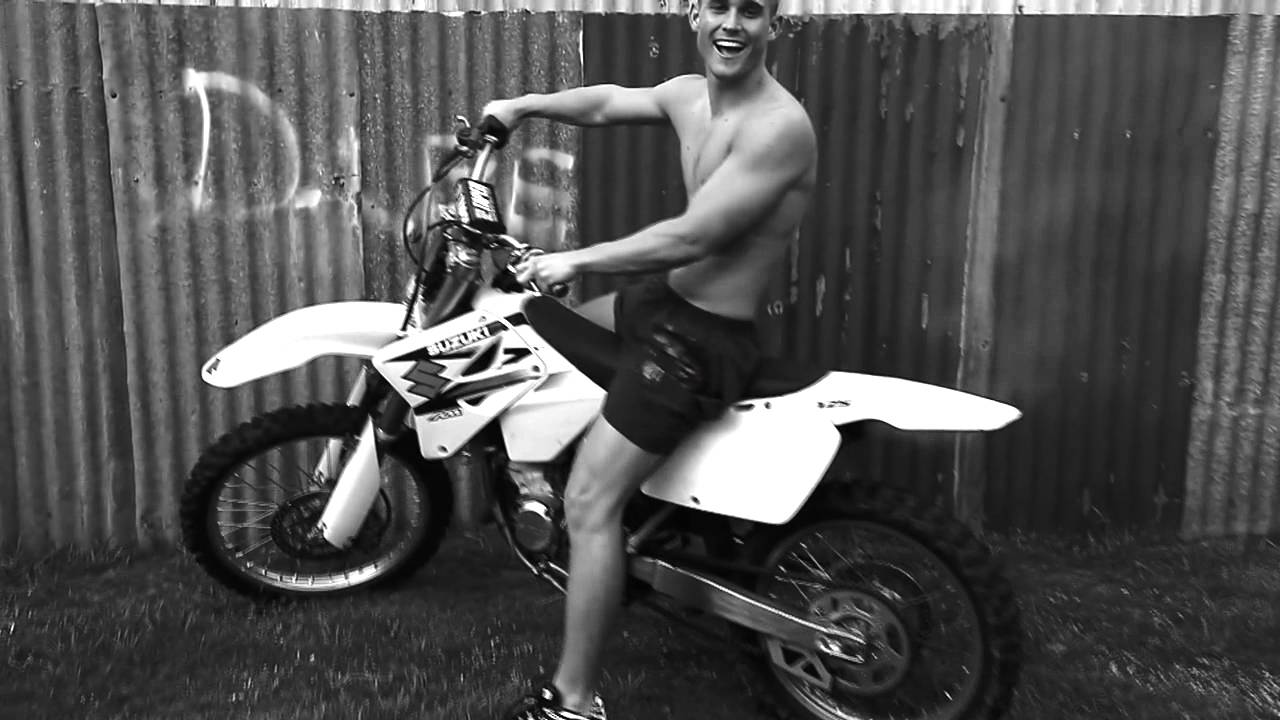 Cute hunk in Nike Tn revs his smoky 2-stroke bike