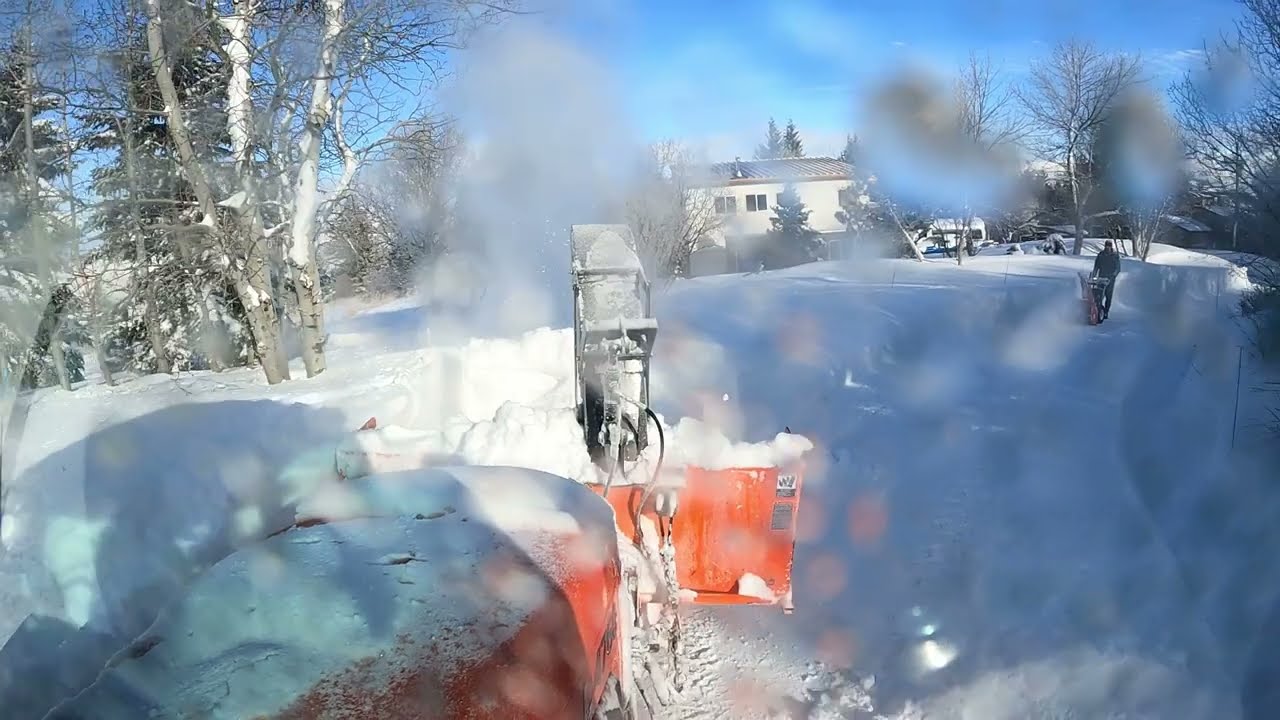 Snowblowing some windblown snowbanks.