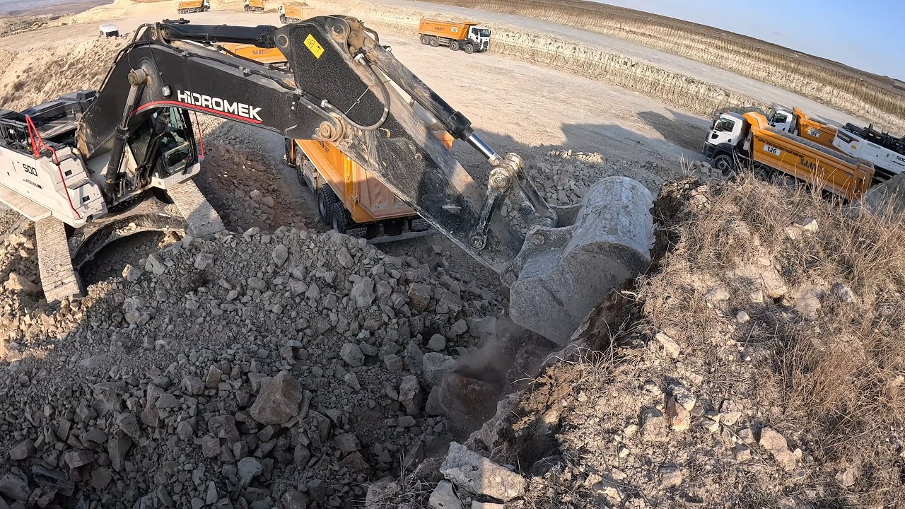 Fast and efficient operator loads trucks.