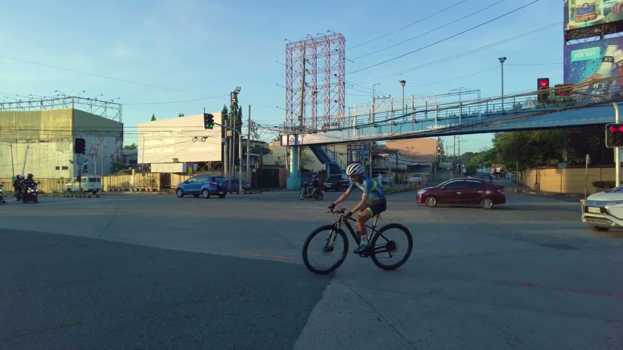 Foreigner bicycling in Metro Manila chaotic traffic.