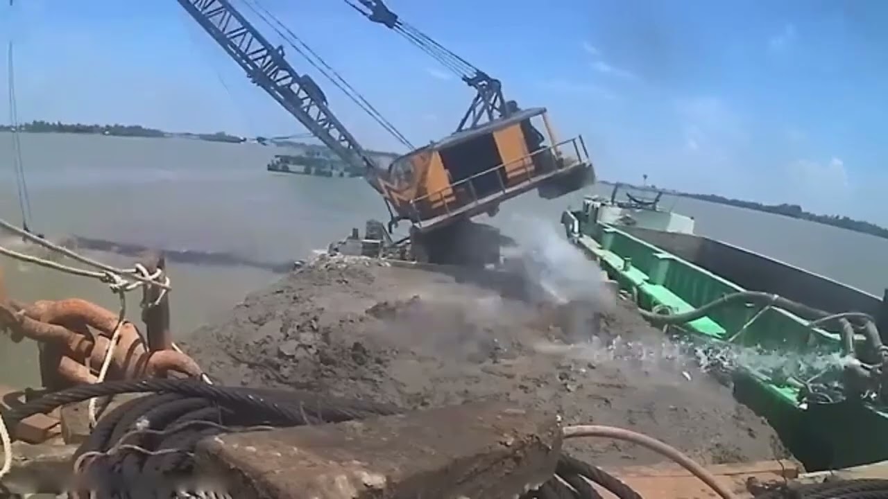 😱 A Heart-Stopping Moment: Crane Falls Into Water! 🏗️💦