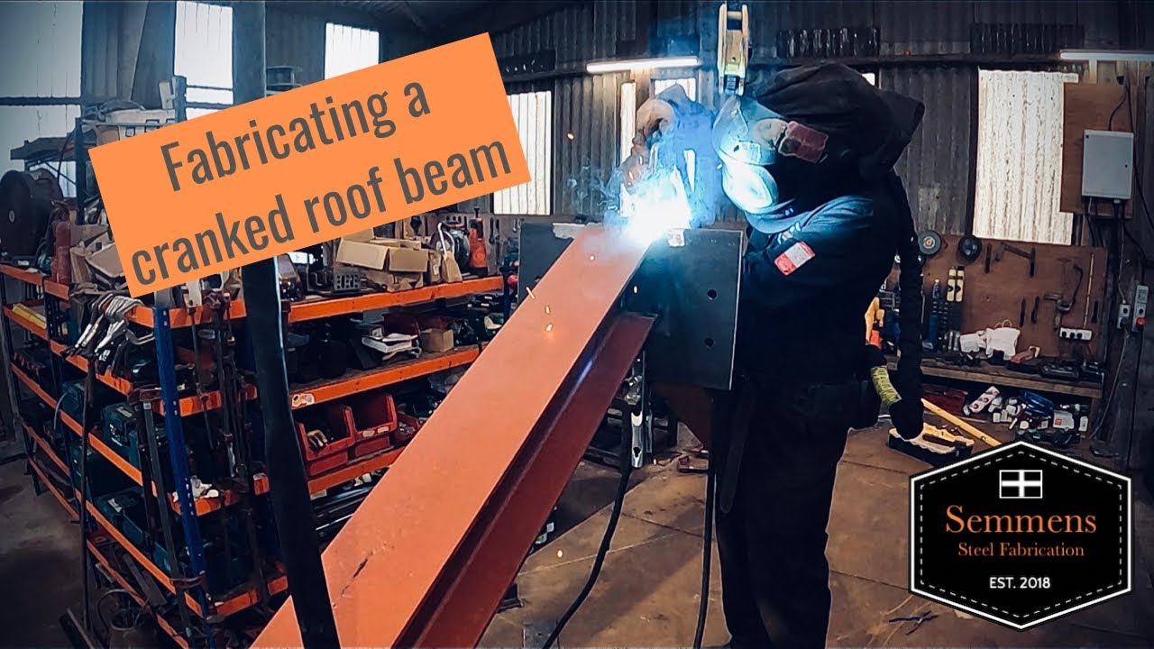 Fabricating a cranked steel roof beam with glulam connection plates