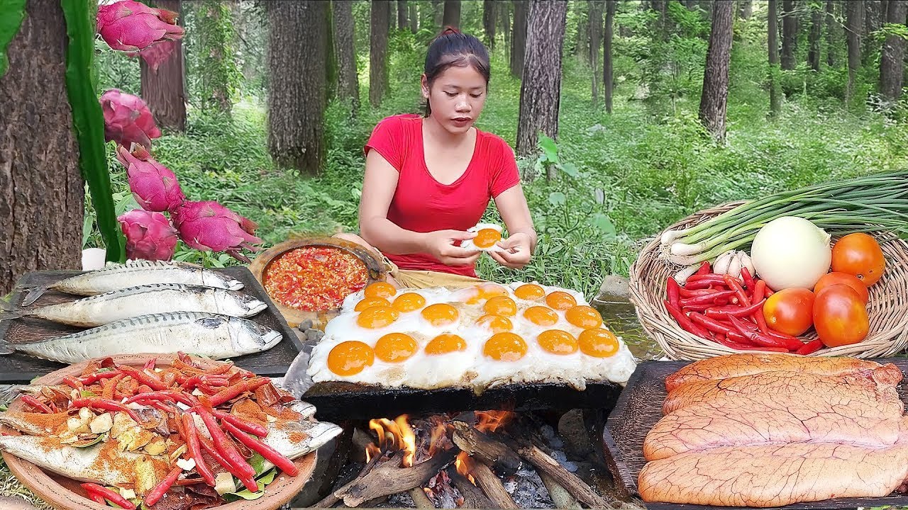 Yummy grill eggs on the rock and cooking Sea fish hot spicy for dinner