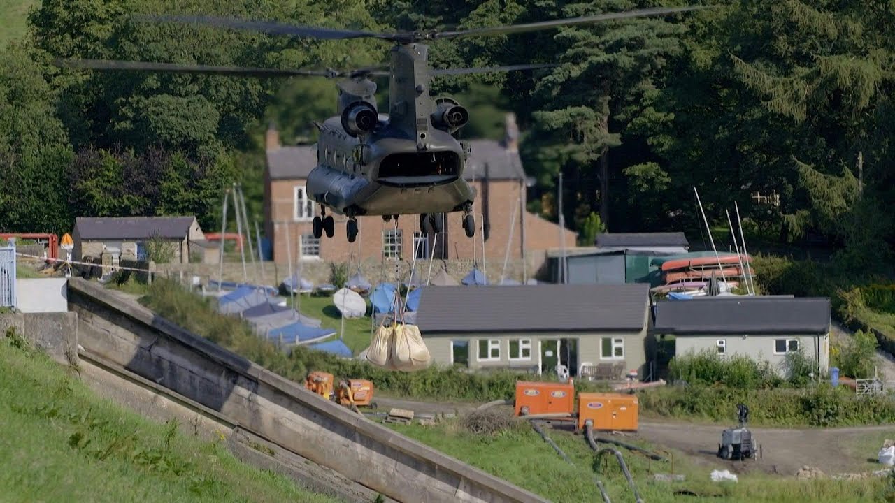 RAF, firefighters scramble to prevent English dam collapse | AFP