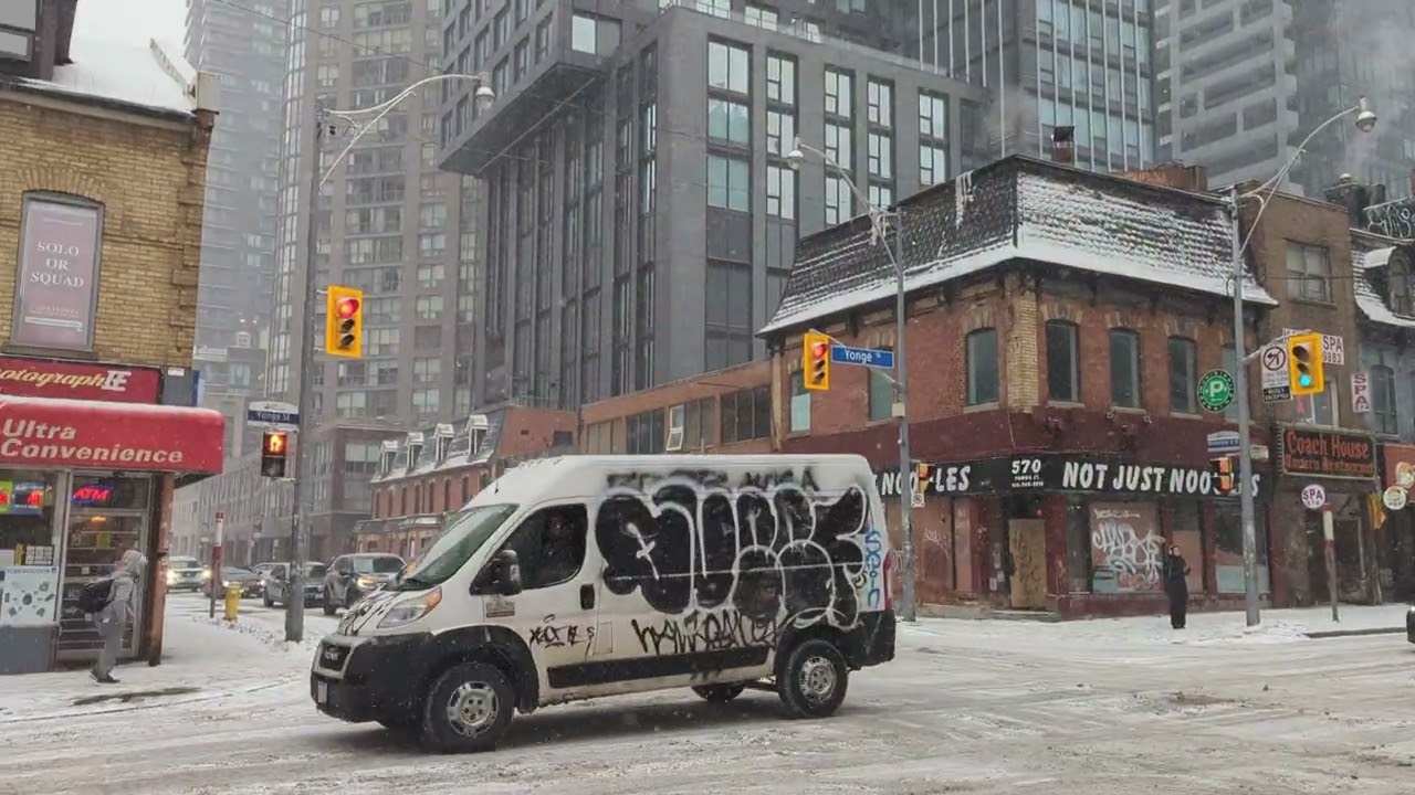 Walking in the snow !   Walking north on Yonge street during a snow storm. Talking local economics 