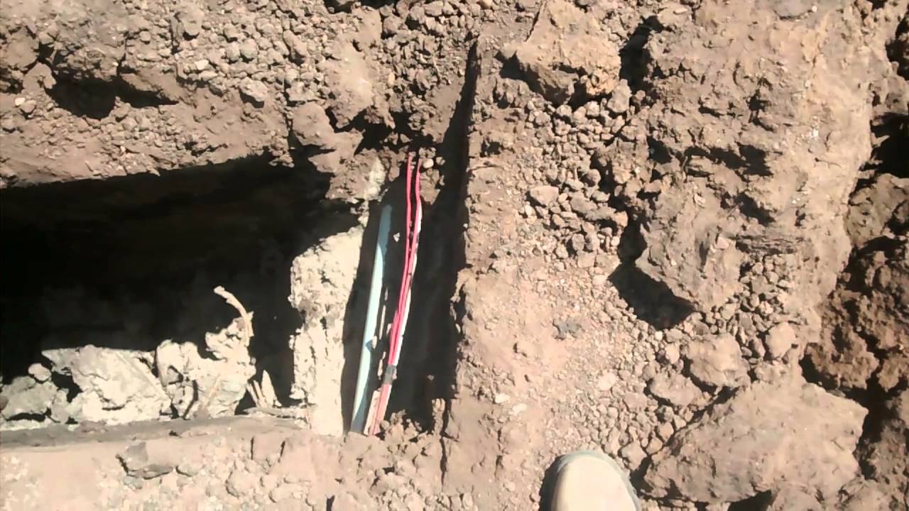 Digging around a water line with a backhoe