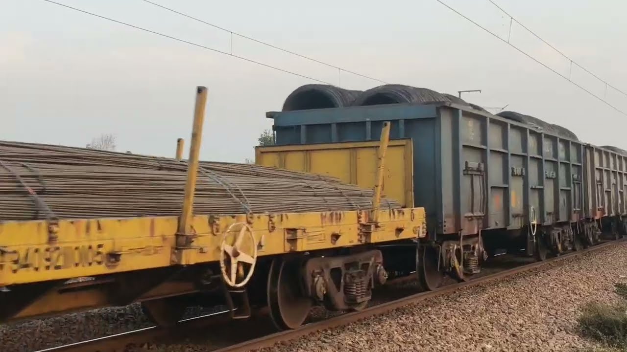 freight train running with fully loaded steel products coils + bars + rods 