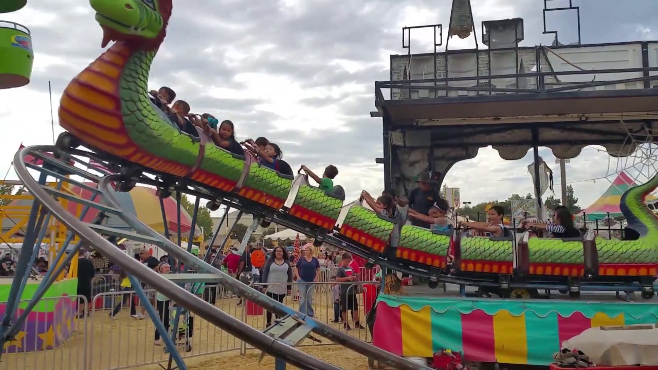 Hannah pretends to ride the Dragon roller coaster, scary rides for kids