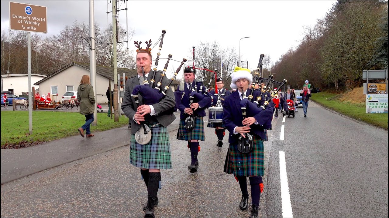 Members of the Vale of Atholl Pipe Band lead Santa and reindeer to 2024 Aberfeldy Christmas Market
