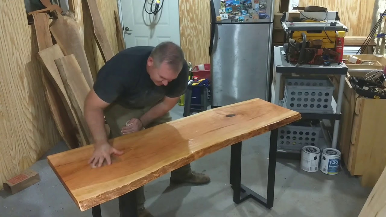 Adding finishing touches to live edge Cherry table