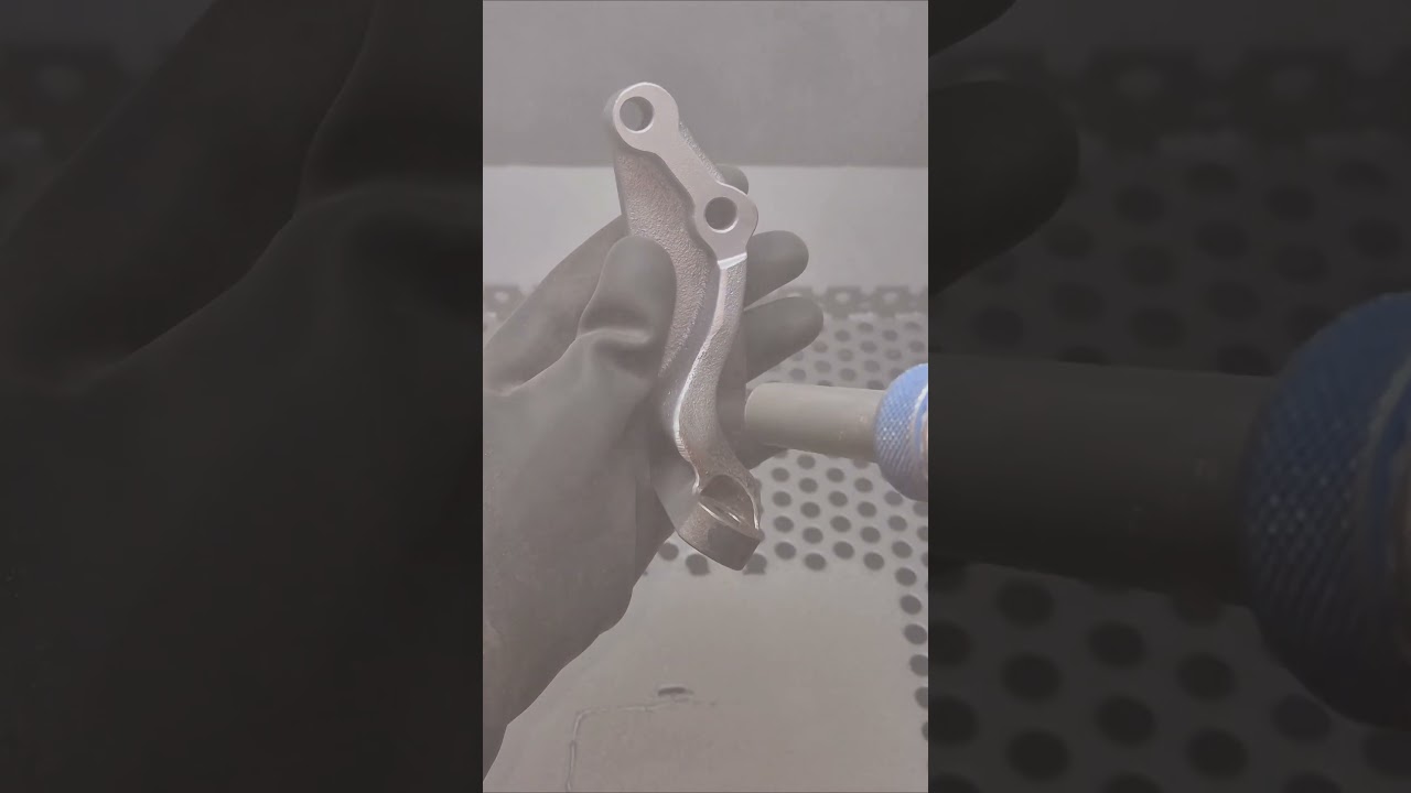 sandblasting a rusty engine part