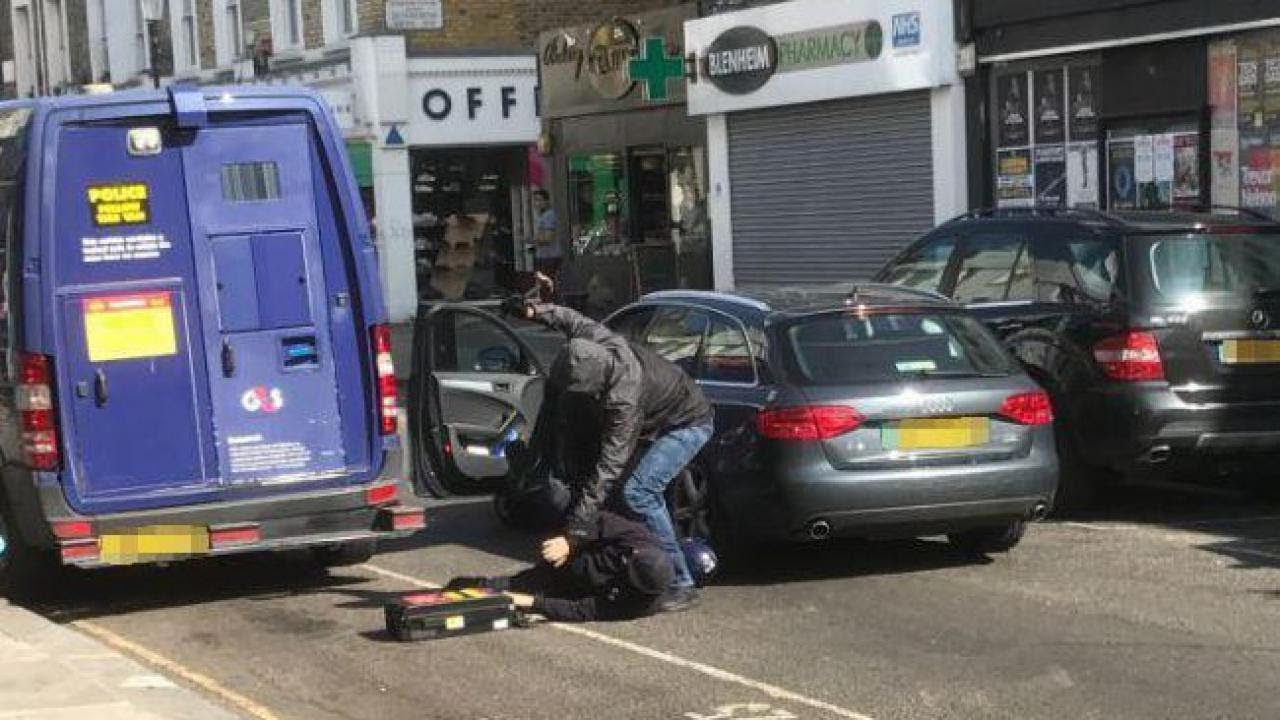 Dramatic photo shows hammer-wielding robber pinning G4S security driver to the floor during